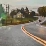 Car driving on road in evening