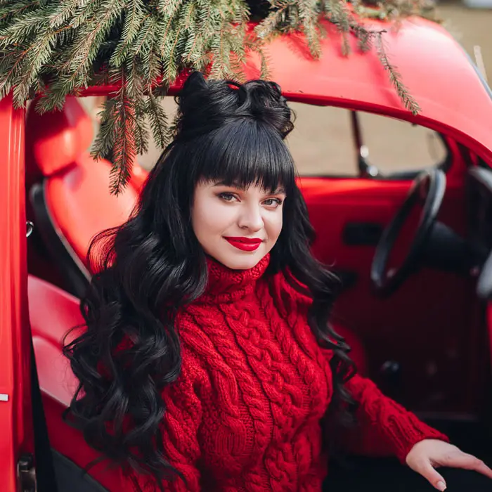 young girl with dark hair sits in a beautiful red HDVHNK7
